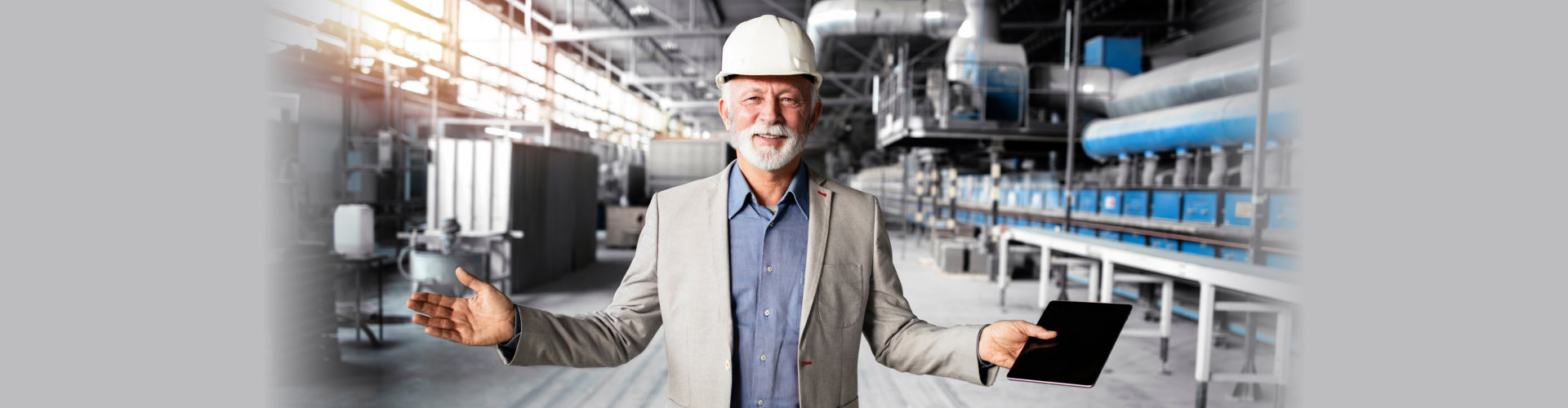 senior with hard hat holding notebook in warehouse