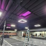 Ceiling upgrade with recessed panels and magenta accent LEDs — ladders set for final aiming