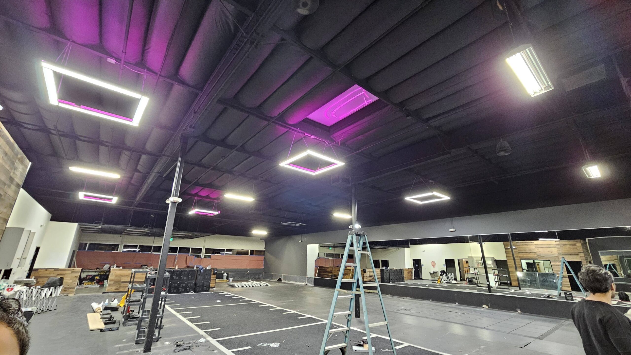 Ceiling upgrade with recessed panels and magenta accent LEDs — ladders set for final aiming